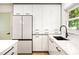 Modern kitchen with sleek white cabinetry, stainless steel appliances, and a stylish black faucet at 3436 Manatee Se Dr, St Petersburg, FL 33705