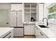 Modern kitchen with sleek white cabinets, stainless steel appliances, and ample storage at 3436 Manatee Se Dr, St Petersburg, FL 33705