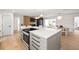 Bright, open kitchen with a large island, modern appliances, and an eat-in dining area at 3436 Manatee Se Dr, St Petersburg, FL 33705