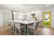 Modern kitchen featuring a large island with seating and a view of the backyard through a bright window at 3436 Manatee Se Dr, St Petersburg, FL 33705