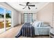 Comfortable main bedroom with private deck access, sliding closet doors and modern ceiling fan at 3436 Manatee Se Dr, St Petersburg, FL 33705
