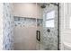 The shower features beautiful custom tilework and convenient built-in shelving at 3436 Manatee Se Dr, St Petersburg, FL 33705