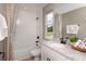 Bright bathroom featuring a tub with shower, granite countertop and window to the backyard at 3472 Timber Crossing Ave, Brandon, FL 33511