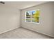 Neutral bedroom with carpet, natural light, and a window that offers a pond view at 3472 Timber Crossing Ave, Brandon, FL 33511
