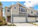 Contemporary townhome showcasing a two-car garage, modern architecture, and neutral color palette at 3472 Timber Crossing Ave, Brandon, FL 33511
