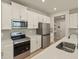 The kitchen features stainless steel appliances, white cabinets and lots of counter space at 3472 Timber Crossing Ave, Brandon, FL 33511