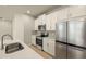 Modern kitchen featuring stainless appliances, beautiful cabinets, and a gray backsplash at 3472 Timber Crossing Ave, Brandon, FL 33511