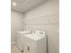 The laundry room has a washer, dryer, and overhead shelving at 3472 Timber Crossing Ave, Brandon, FL 33511