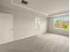 Spacious main bedroom features recessed lighting, carpet, tray ceiling, and a view to the outside at 3472 Timber Crossing Ave, Brandon, FL 33511