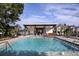 Community pool with crystal clear water, fountains, and shaded lounge area, offering a refreshing and relaxing atmosphere at 3472 Timber Crossing Ave, Brandon, FL 33511