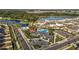 Aerial view of the community pool, splash pad, playground, and community center with a parking lot at 35780 Sunflower Hill Dr, Zephyrhills, FL 33541