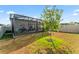 Backyard featuring a screened in patio and well maintained lawn at 35780 Sunflower Hill Dr, Zephyrhills, FL 33541