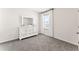Light filled bedroom features a modern dresser, mirror, and plush gray carpet at 35780 Sunflower Hill Dr, Zephyrhills, FL 33541