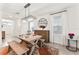 Sunlit dining area features hardwood floors, decorative mirror, and wooden table with bench seating at 35780 Sunflower Hill Dr, Zephyrhills, FL 33541