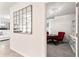 Hallway featuring view into the dining area with decorative mirror and access to the living room at 35780 Sunflower Hill Dr, Zephyrhills, FL 33541