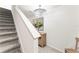 Hallway featuring staircase, stylish light fixture, and a decorative mirror at 35780 Sunflower Hill Dr, Zephyrhills, FL 33541