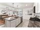 Open-concept kitchen featuring granite countertops, stainless steel appliances, and an adjacent dining area at 35780 Sunflower Hill Dr, Zephyrhills, FL 33541