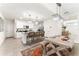 Bright eat-in kitchen features white cabinets, a center island with seating and elegant chandeliers at 35780 Sunflower Hill Dr, Zephyrhills, FL 33541