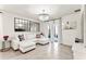Bright living room with hardwood floors, modern light fixtures, and white couch with floral pillows at 35780 Sunflower Hill Dr, Zephyrhills, FL 33541