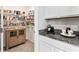 Walk-in pantry with wooden cabinet, wire shelves, and granite counter with a coffeemaker at 35780 Sunflower Hill Dr, Zephyrhills, FL 33541