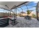 Relax on the screened patio complete with an outdoor table and comfortable seating at 35780 Sunflower Hill Dr, Zephyrhills, FL 33541