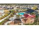 Community pool, splash pad and play area with picnic tables surrounded by lush tropical landscaping at 35780 Sunflower Hill Dr, Zephyrhills, FL 33541