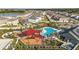Community center with community pool, playground and splash pad surrounded by lush landscaping at 35780 Sunflower Hill Dr, Zephyrhills, FL 33541