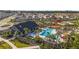 Community pool with lounge chairs and a covered picnic area surrounded by lush landscaping in Gathering-friendly neighborhood at 35780 Sunflower Hill Dr, Zephyrhills, FL 33541