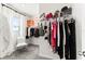 Organized walk-in closet with ample shelving, hanging racks, and a comfy decorative chair at 35780 Sunflower Hill Dr, Zephyrhills, FL 33541