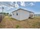 Backyard showcasing exterior elevation and deck with stairs at 3730 Elmwood Dr, Holiday, FL 34691