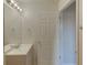 Bathroom with single sink vanity, mirror, and tiled floors at 3730 Elmwood Dr, Holiday, FL 34691