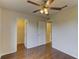 Bright bedroom features hardwood floors, ceiling fan, and walk-in closet for ample storage at 3730 Elmwood Dr, Holiday, FL 34691