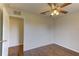 Bedroom featuring wood flooring, a ceiling fan and doorway to another room at 3730 Elmwood Dr, Holiday, FL 34691