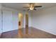 Bedroom with wood floors, a ceiling fan and access to an ensuite bathroom and closet at 3730 Elmwood Dr, Holiday, FL 34691
