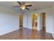 A comfortable bedroom with wood flooring, a ceiling fan, and access to an ensuite bathroom and closet at 3730 Elmwood Dr, Holiday, FL 34691