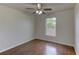 Cozy bedroom featuring wood flooring, a ceiling fan, and a bright window at 3730 Elmwood Dr, Holiday, FL 34691