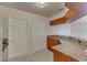 Open kitchen design with granite countertops, ample cabinets and a view of additional rooms at 3730 Elmwood Dr, Holiday, FL 34691