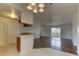 Open concept living area with luxury vinyl plank flooring leading to kitchen and dining space at 3730 Elmwood Dr, Holiday, FL 34691