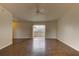 Spacious living room featuring wood flooring and natural light from the sliding glass doors at 3730 Elmwood Dr, Holiday, FL 34691