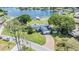 Aerial view of lakefront home featuring a private dock and manicured lawn at 3938 Lake Joyce Dr, Land O Lakes, FL 34639