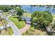 Lakefront property with lush landscaping and a private dock provides serene outdoor living and easy access to the water at 3938 Lake Joyce Dr, Land O Lakes, FL 34639