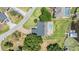 Aerial view of a lakefront home showcasing a backyard pool and private dock overlooking the tranquil lake at 3938 Lake Joyce Dr, Land O Lakes, FL 34639