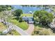 Overhead view of a lakefront house with a private boat dock and lush lawn at 3938 Lake Joyce Dr, Land O Lakes, FL 34639