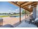 Spacious covered patio offering a view of the pool and the serene lake at 3938 Lake Joyce Dr, Land O Lakes, FL 34639