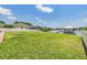 Expansive grassy backyard leads to a waterfront view with a charming gazebo on the lake at 3938 Lake Joyce Dr, Land O Lakes, FL 34639