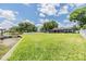 Spacious backyard with a long grassy area stretching to a dock area, perfect for recreation at 3938 Lake Joyce Dr, Land O Lakes, FL 34639