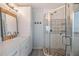 Well-lit bathroom features a shower with decorative tiles and a white vanity at 3938 Lake Joyce Dr, Land O Lakes, FL 34639