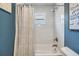 Clean bathroom featuring a shower with white subway tile, shower curtain and window at 3938 Lake Joyce Dr, Land O Lakes, FL 34639