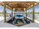 Covered boat dock featuring a boat lift and lounge chairs, offering serene waterfront views at 3938 Lake Joyce Dr, Land O Lakes, FL 34639