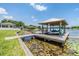 Lakeside boat dock with a boat lift and lounge area, providing direct water access at 3938 Lake Joyce Dr, Land O Lakes, FL 34639